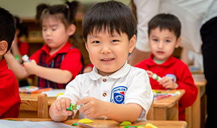 A child smiling in class