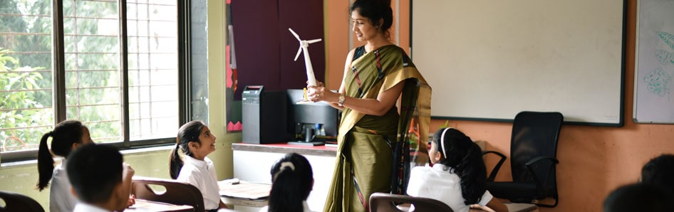 Indian teacher teaching concepts of windmill in the classroom to students