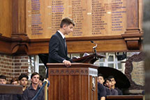 Former student giving a speech at a podium