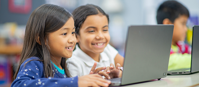 Students looking at a laptop