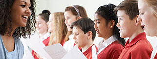 Teacher and pupils singing 