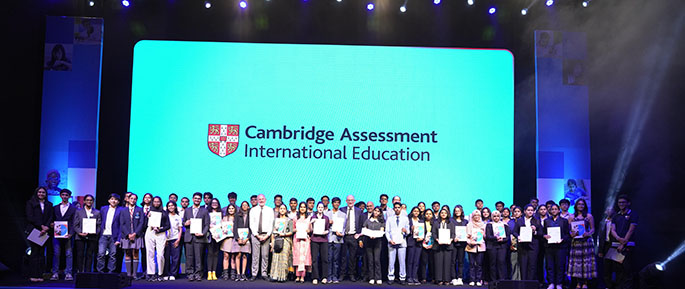Students on stage with awards