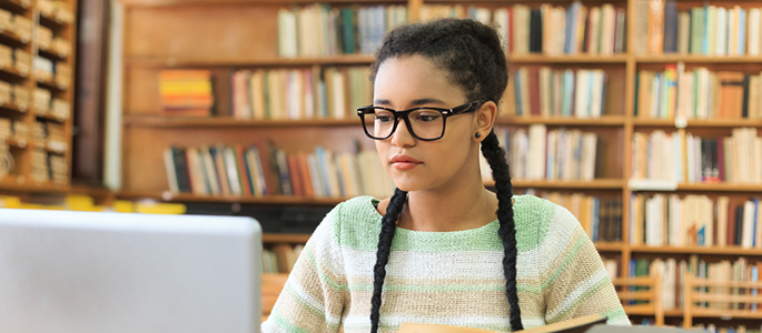student studying at the library