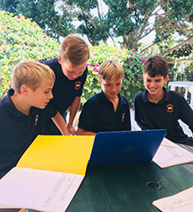 Students looking at a laptop