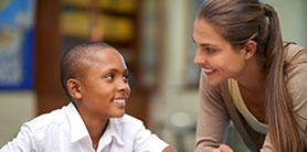 a male student and a female teacher both smiling