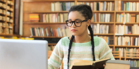student studying at the library