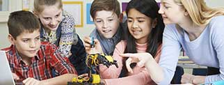 Pupils and teacher in Science lesson studying robotics