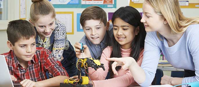 Pupils and teacher in Science lesson studying robotics